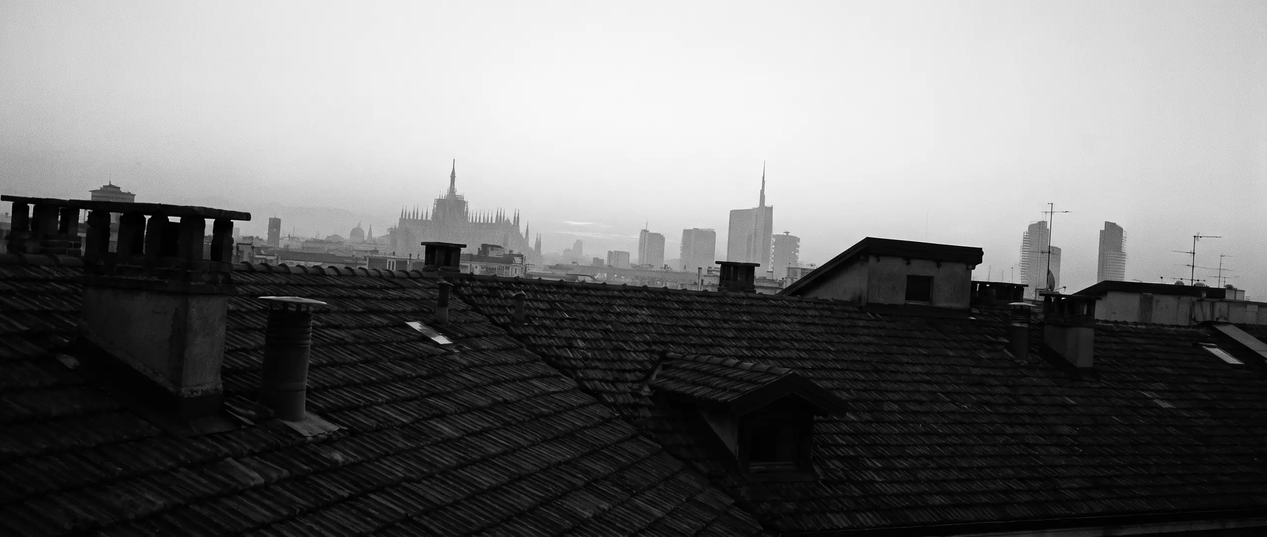 Milano rooftops with the Duomo in morning mist, black and white